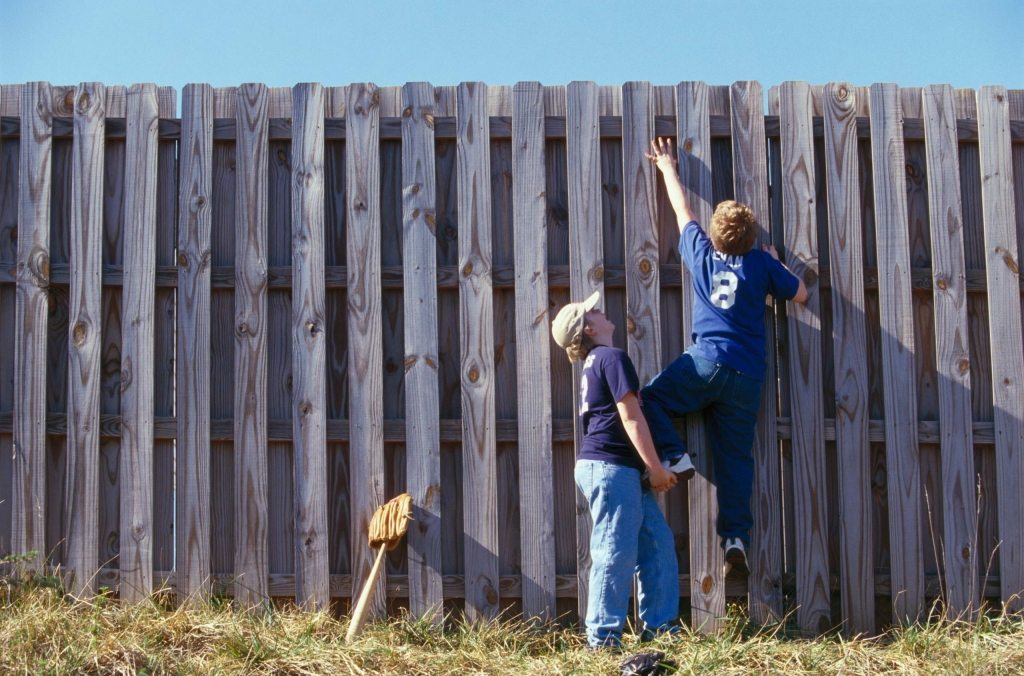 kids climbing a fence